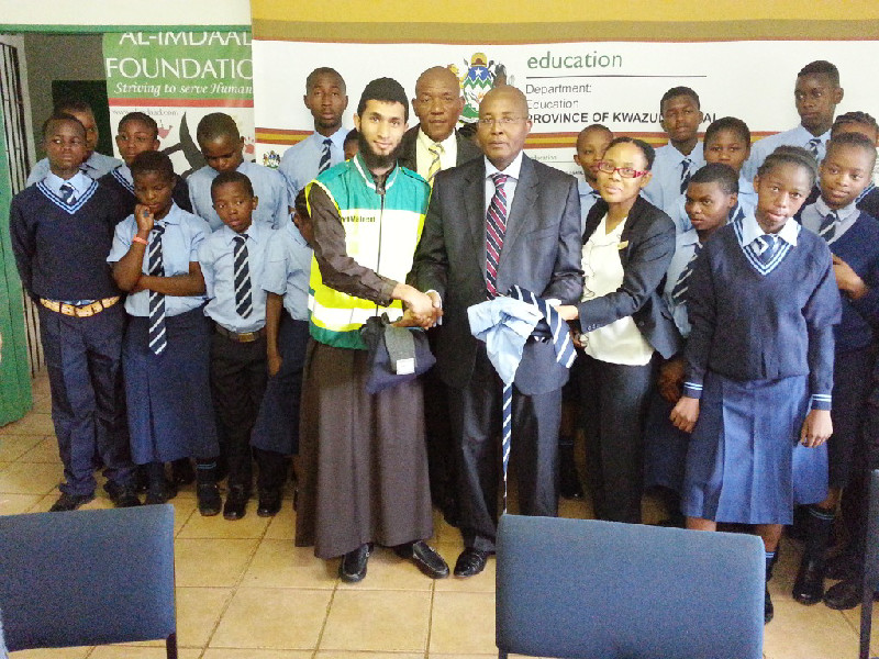 The-Al Imdaad Foundation together with HoD of Education in KZN Dr Nkosinathi SP Sishi hand over uniforms to Khabazela High School