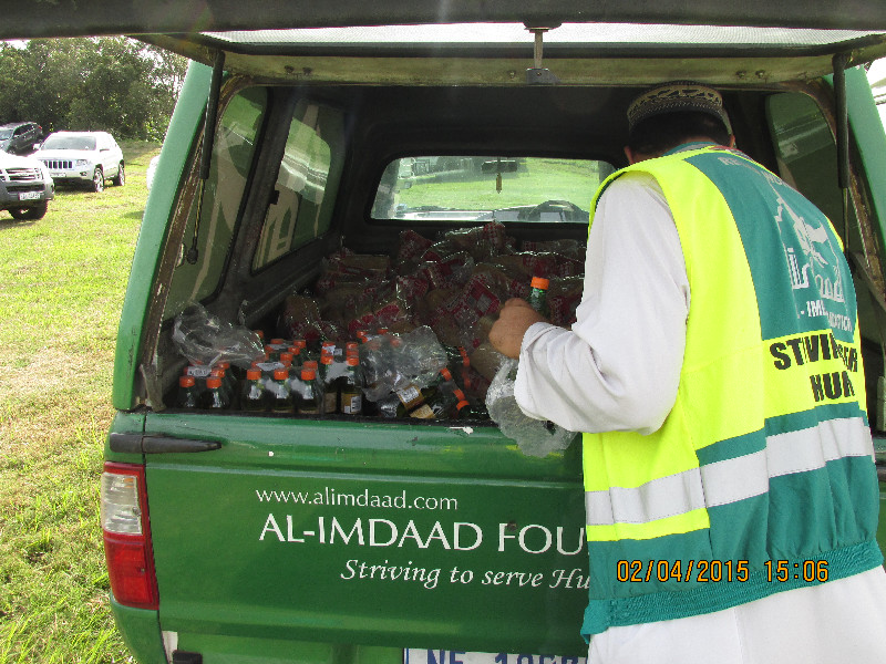 Al-Imdaad Foundation team members ready the food and beverages to be distributed to the foreigners