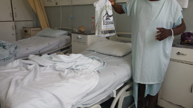 A cataract patient receives a snack pack from the Al-Imdaad Foundation team during the cataract eye surgery programme at McCord Hospital in Durban